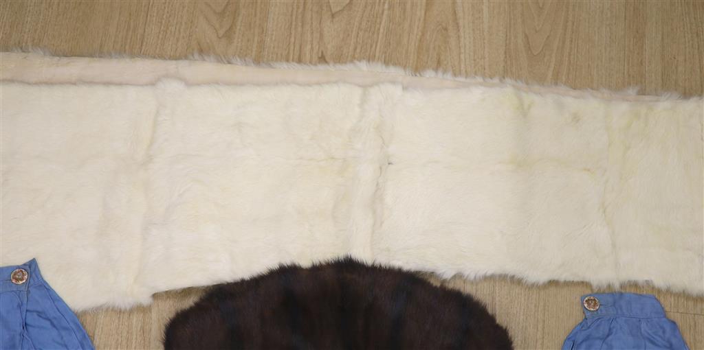 A brown fur muff and a white fur stole